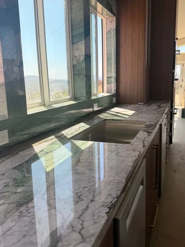 Polished stone counter run with an undermount sink