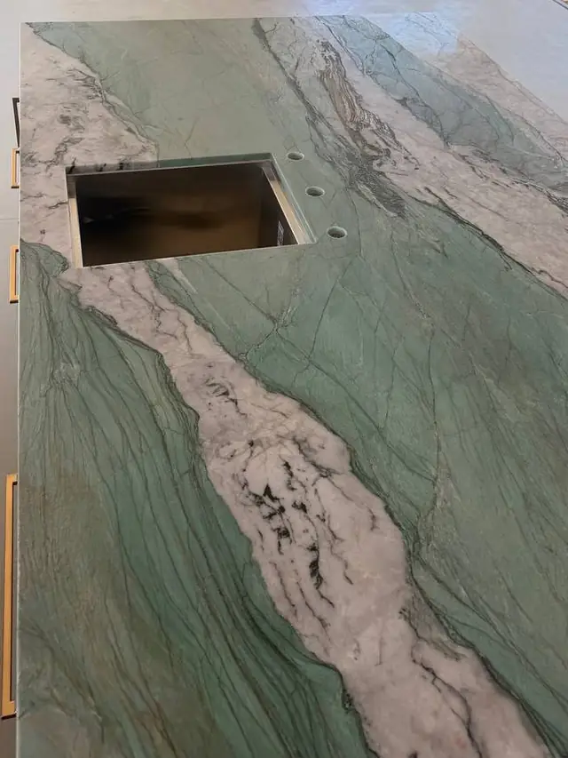 Sink cutout and faucet holes in a stone slab