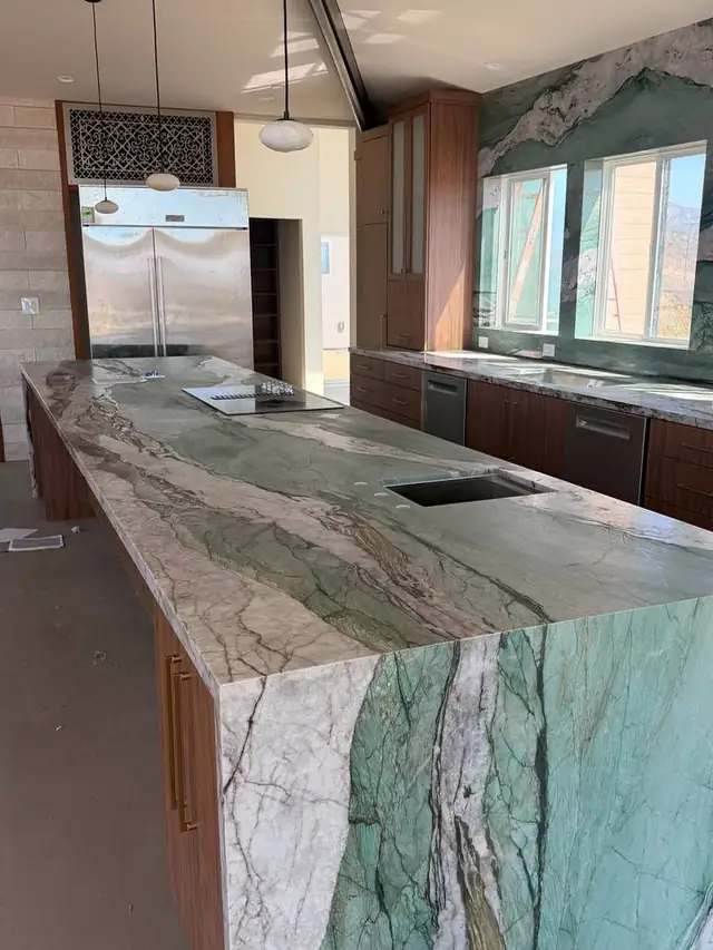 Green stone island with a waterfall edge