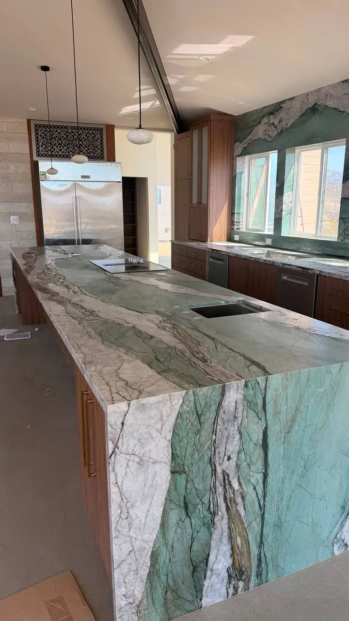 Green stone island with a waterfall edge